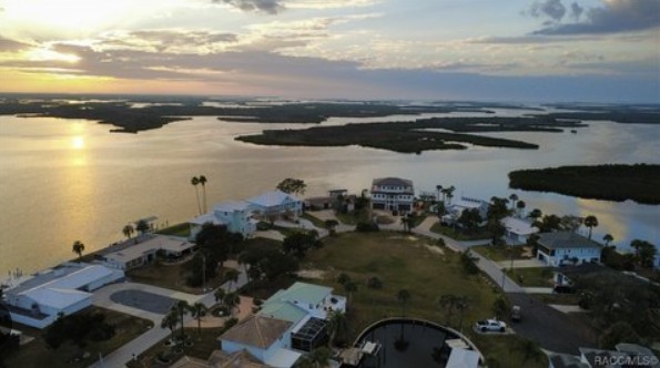Aerial sunset view of a waterfront neighborhood for an AI home search Citrus County article.