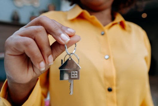 Home buyer holding house keys after purchasing with a conventional loan