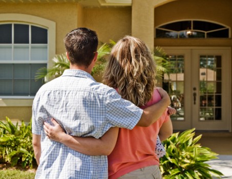Couple standing outside their new home in Citrus County after buying with a USDA loan