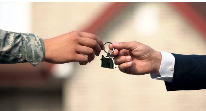 Veteran receiving house keys representing VA home loan benefits for military home buyers