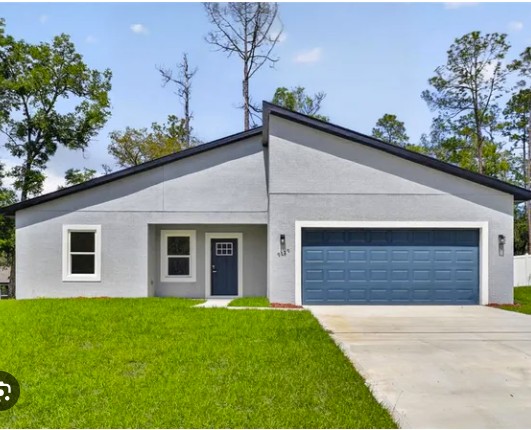 new construction home in Citrus County Florida with modern exterior, driveway, and attached garage