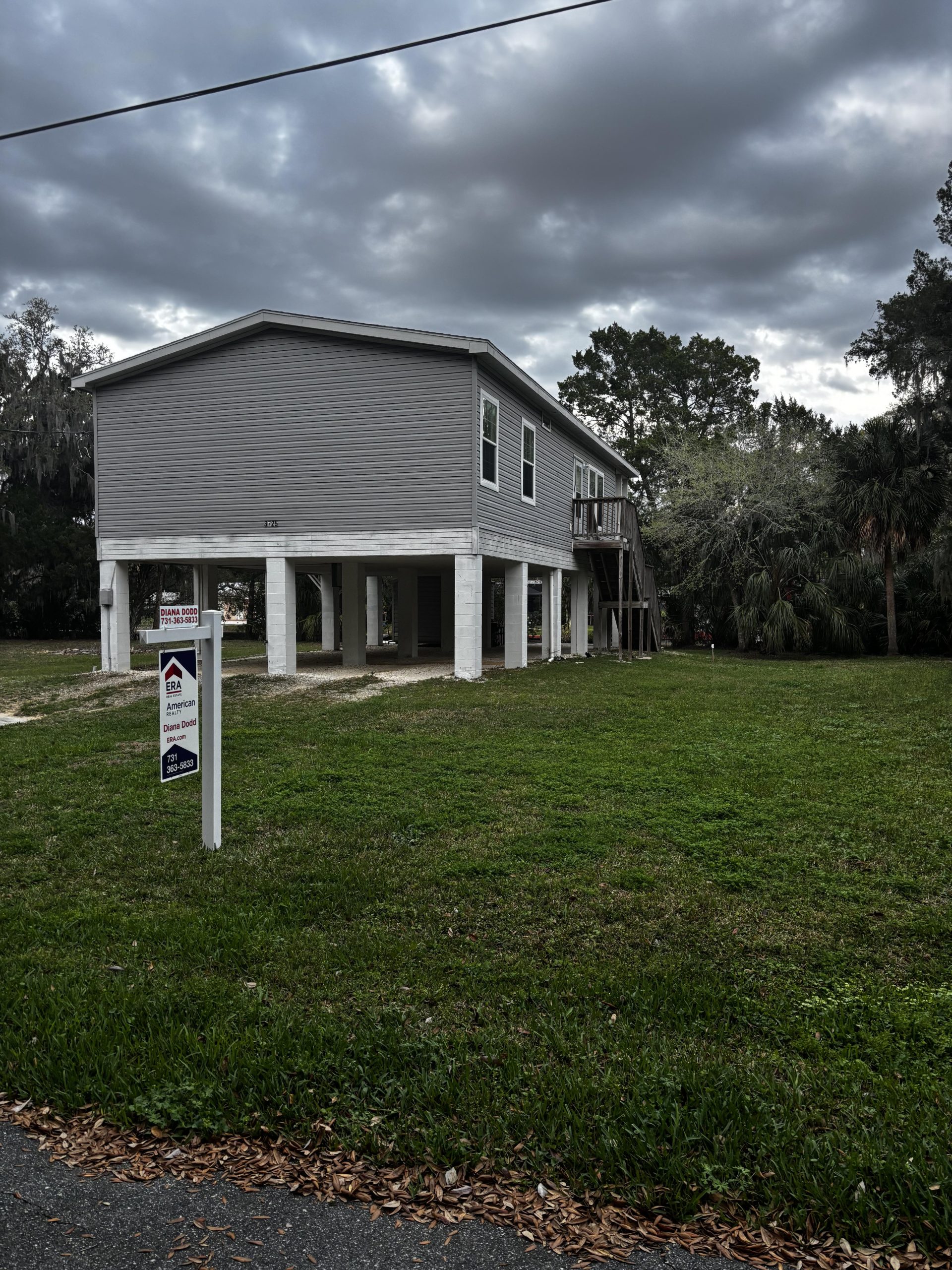 Elevated waterfront-style home in Citrus County Florida with storm clouds, highlighting homeowners and flood insurance considerations